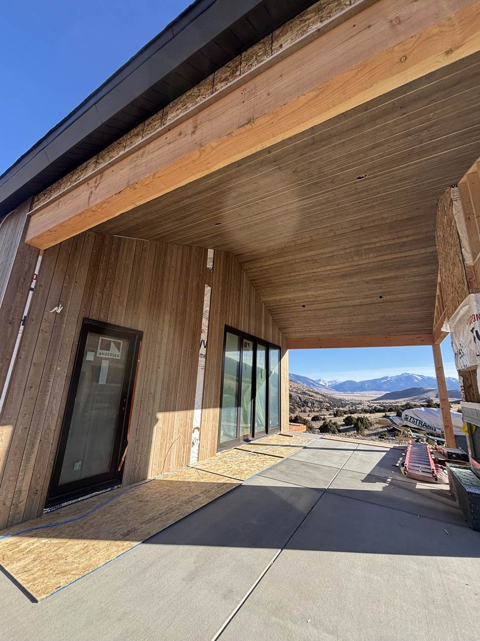 Covered deck and patio built by Tame Dog Solutions, with mountain views