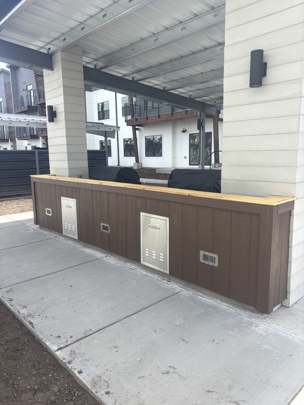 Painted siding on an outdoor grill station at an apartment complex