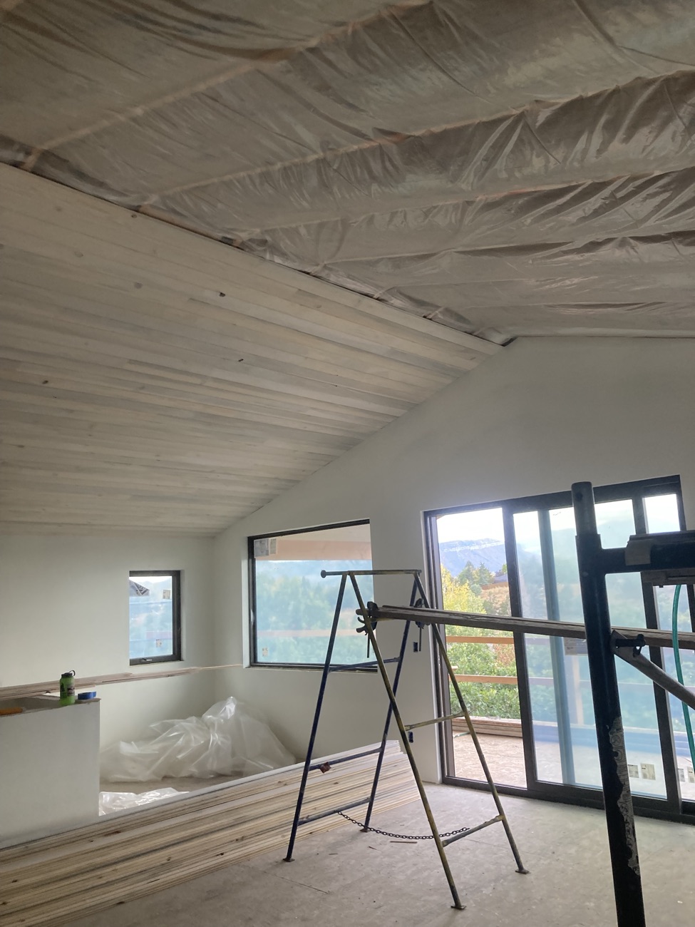 Tongue-and-groove ceiling going up in a vaulted room
